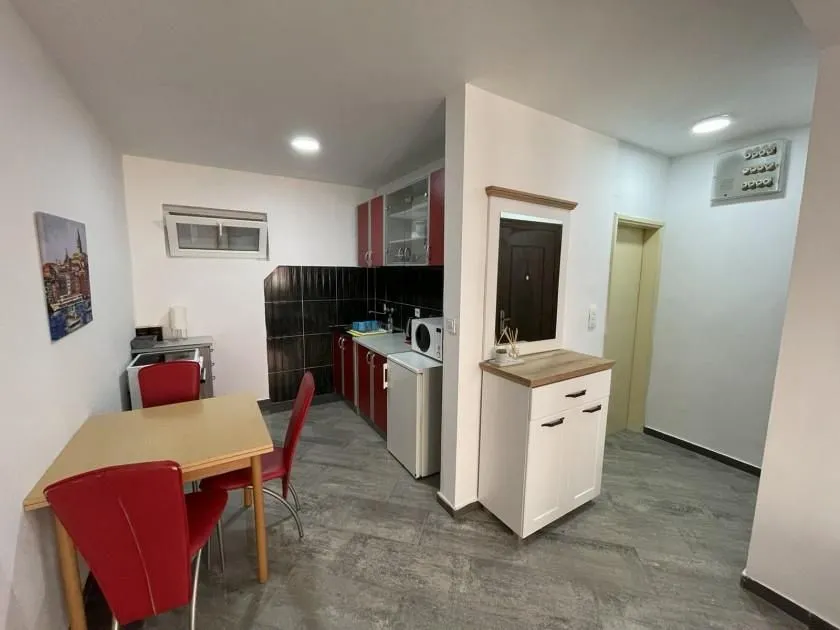 Small kitchen with a dining table and chairs.