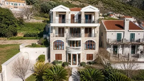 Front view of a multi-story stone facade house with a landscaped yard. - image 10