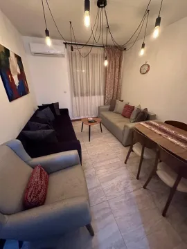 Living room with sofa set, armchair, and dining table. - image 4