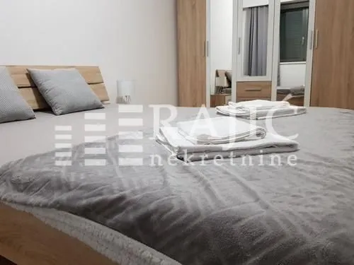 Furnished bedroom with a large double bed and wardrobe.