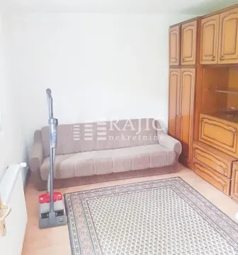 Living room with a sofa and wooden wardrobes. - image 2