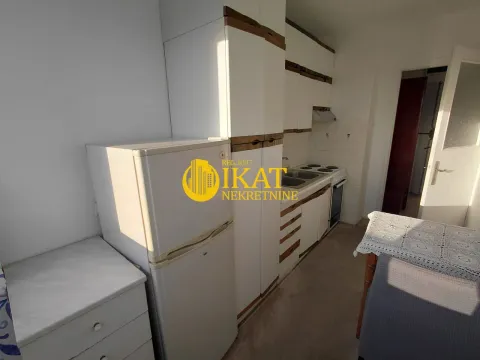 Smaller kitchen with white cabinets and a refrigerator. - image 8