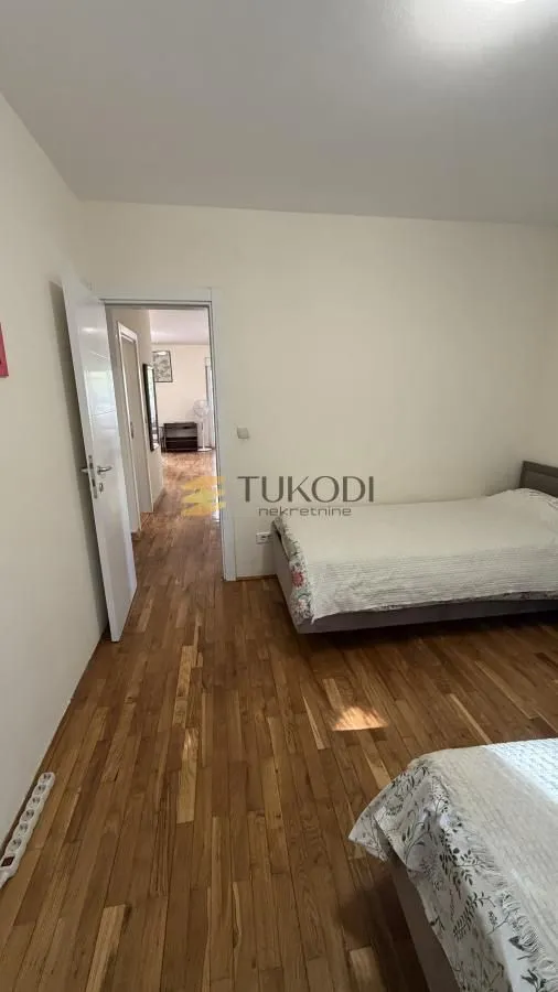 Bedroom with two beds and a view of the hallway.