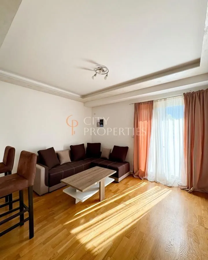 Living room with a corner sofa, coffee table, and access to the terrace.