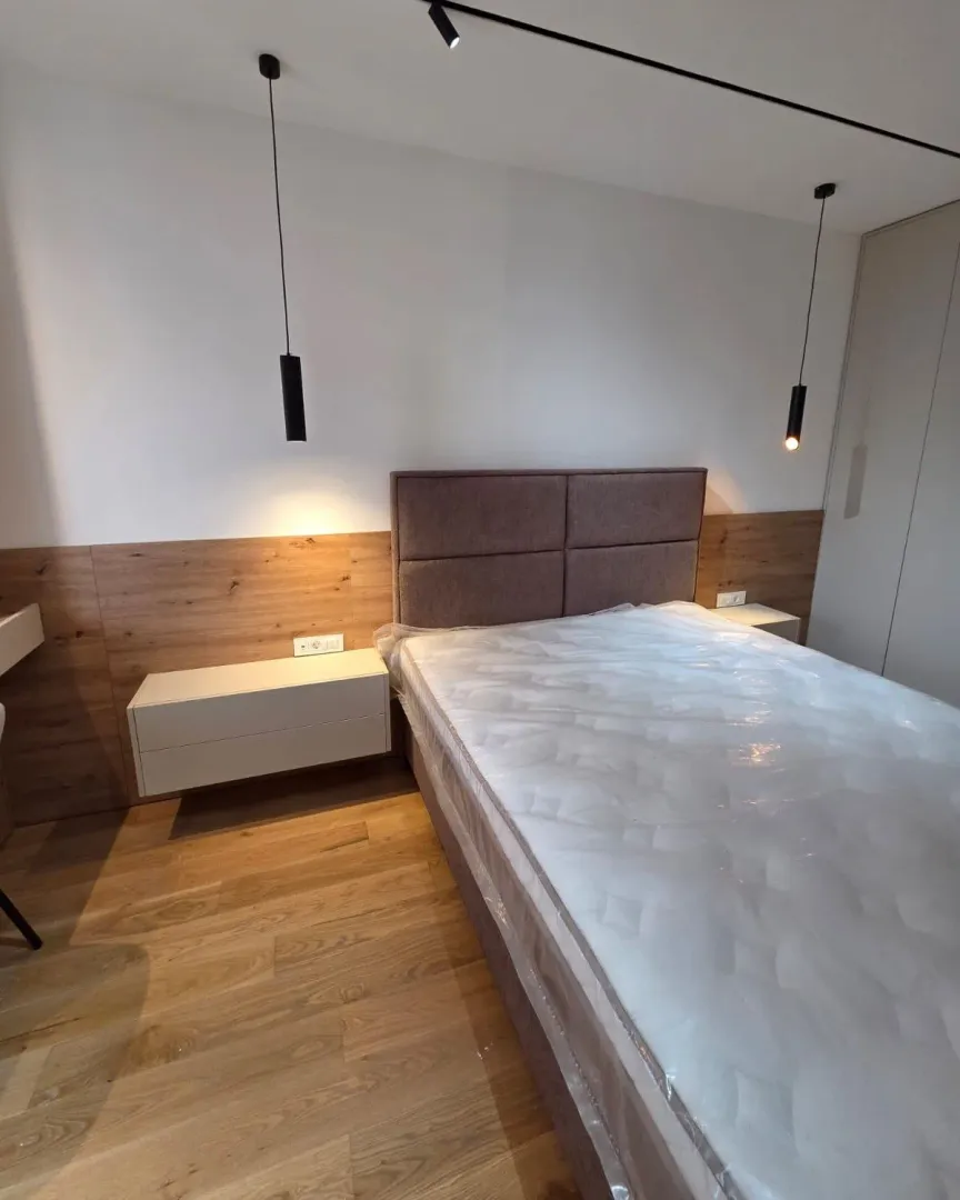Modernly furnished bedroom with a double bed.
