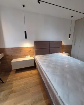Modernly furnished bedroom with a double bed. - image 8