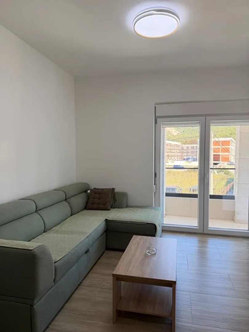 Living room with a sofa and access to the terrace.