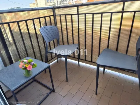 Small furnished balcony with chairs and a small table. - image 7