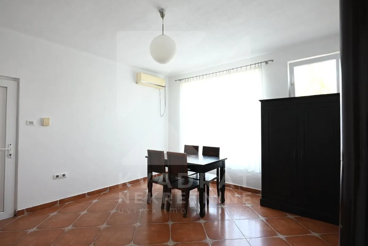 Bright room with a dining table and chairs near the window.