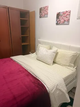 Bedroom with a double bed and a wooden wardrobe. - image 6