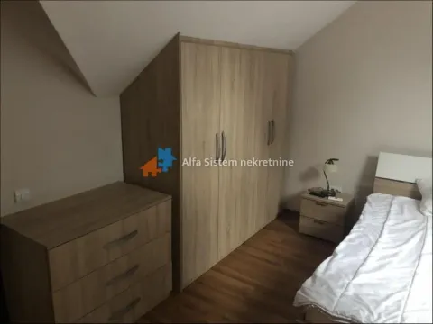 Furnished bedroom with a double bed, large wardrobe, and chest of drawers. - image 13