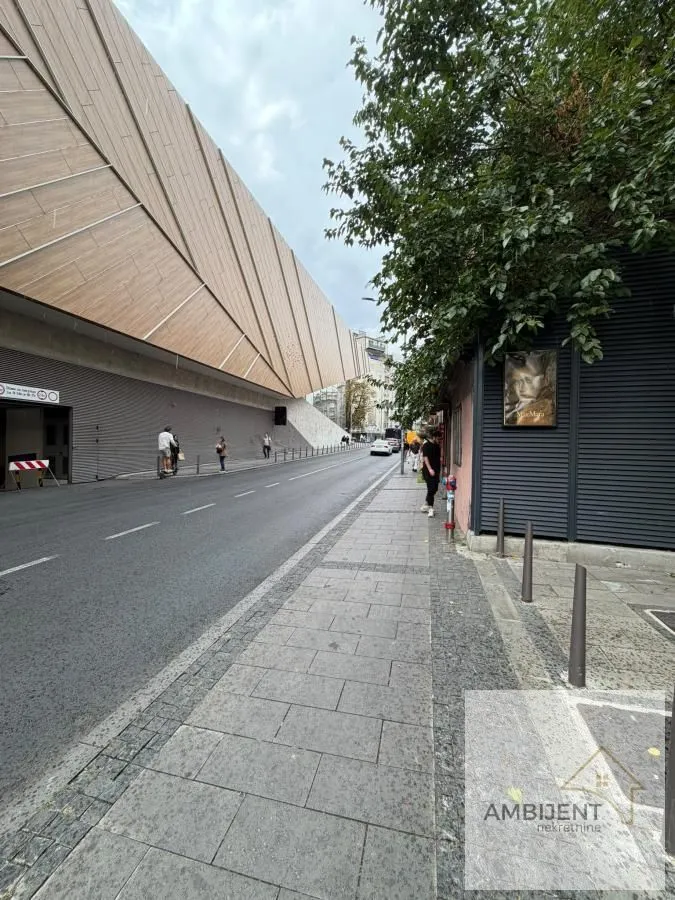 View of the street and building exterior with a sidewalk.
