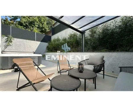 Furnished terrace with seating area and hot tub. - image 15