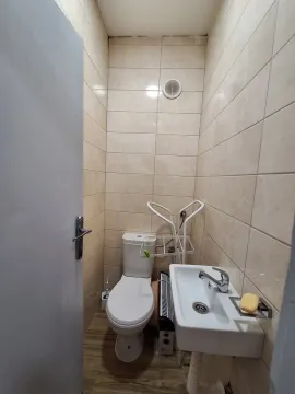 Manje kupatilo obloženo keramičkim pločicama sa toaletom i umivaonikom. - image 10