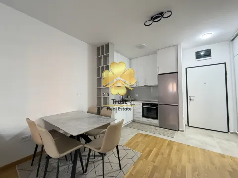 Modern kitchen with a dining area and white cabinets. - image 5