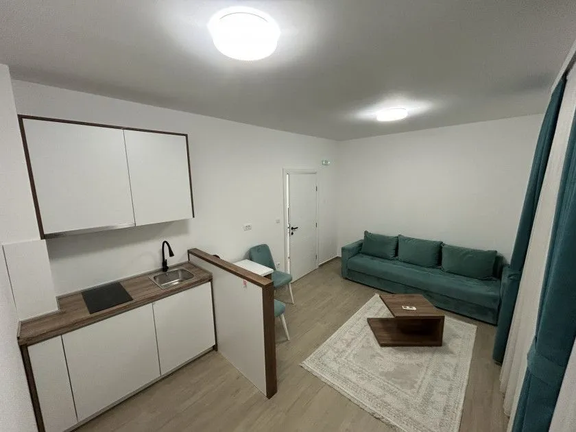 Modern living room with a kitchen and dining area.