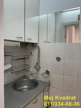 Small kitchen with a sink, wall cabinets and wall tiles. - image 5