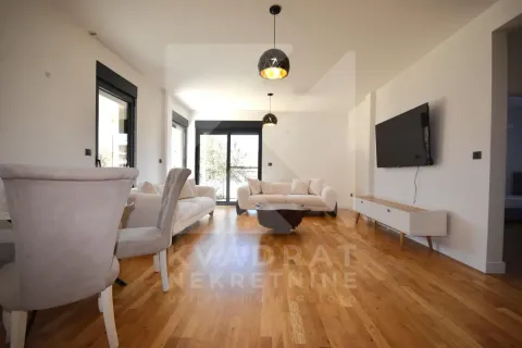 Spacious living room with a sofa set, dining table and hardwood flooring. - image 2