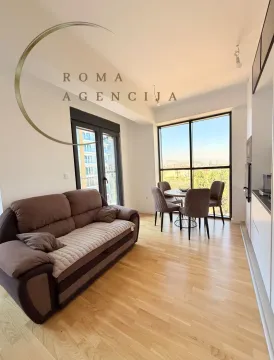Living room with dining area and kitchen in a bright space. - image 4