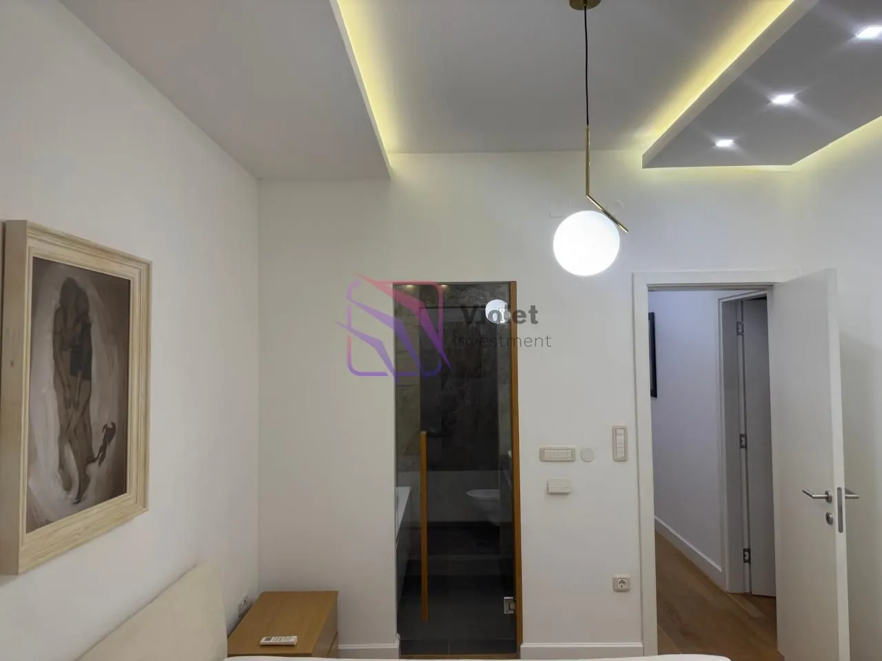Pogled na spavaću sobu sa detaljima enterijera i rasvjetom.