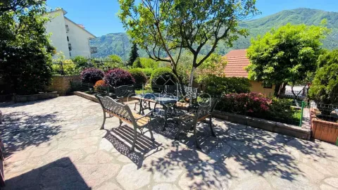 Paved courtyard with seating furniture and greenery. - image 8