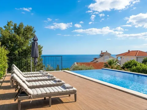 Terrace with a swimming pool, sun loungers and a sea view. - image 4