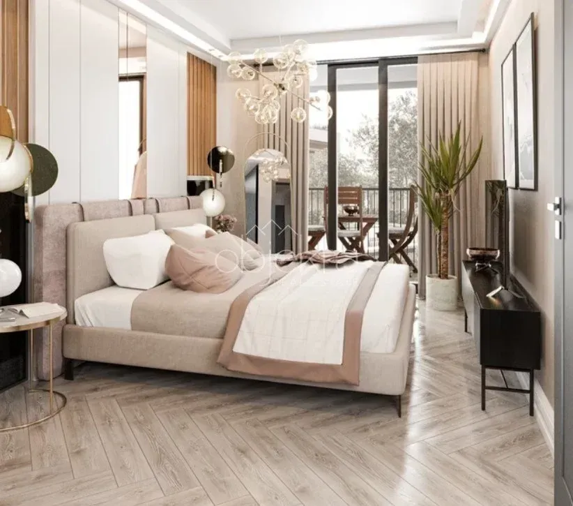 Modern bedroom with a double bed, parquet flooring, and access to the terrace.