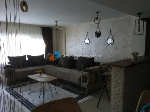 Living room with a corner sofa, coffee table, and a bar counter. - image 2