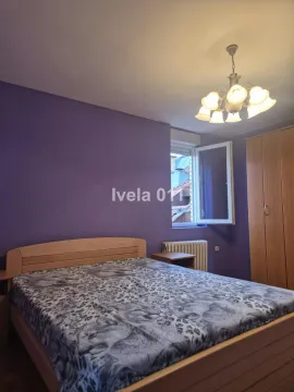 Furnished bedroom with a double bed and purple walls. - image 14
