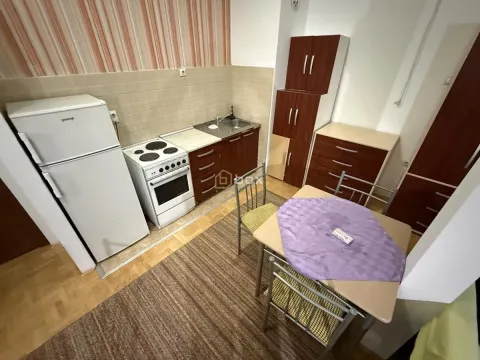 Smaller kitchen with a dining table and refrigerator. - image 6