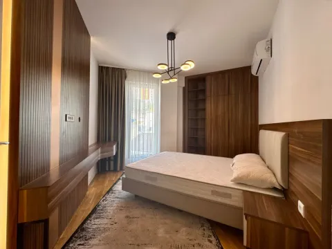 Modern bedroom with a double bed, built-in wardrobe, and wooden wall paneling. - image 15