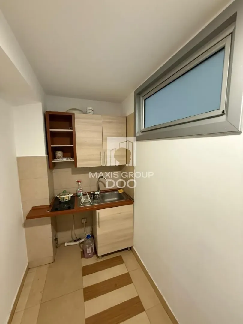 Smaller kitchen with wooden units and a sink.