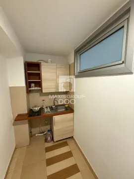 Smaller kitchen with wooden units and a sink. - image 12