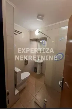 Small bathroom with a walk-in shower, washbasin, and toilet. - image 3