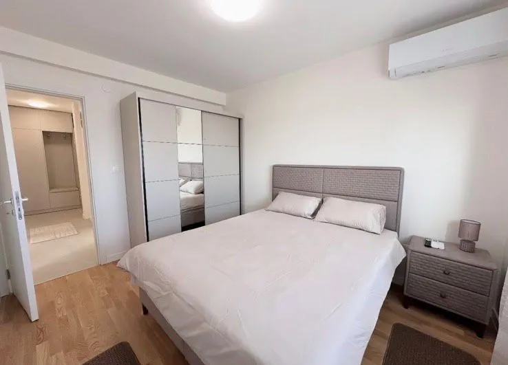 Bedroom with a double bed, wardrobe and nightstand.