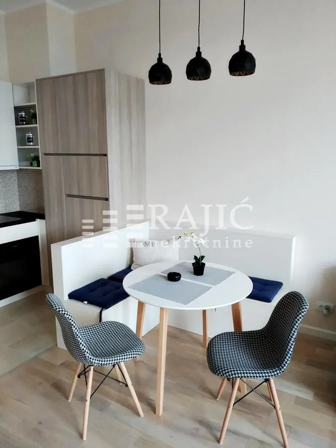 Dining area with a table, chairs, and corner bench as part of the kitchen.