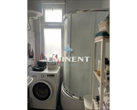 Bathroom with a shower cabin and a washing machine. - image 2