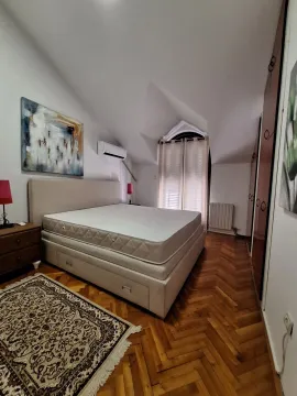 Bedroom with a double bed, wooden parquet flooring, and a wardrobe. - image 15