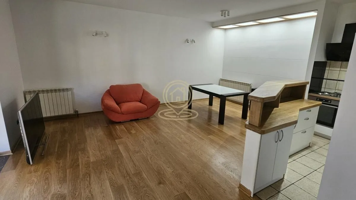 Living room with dining area and a view of the kitchen.