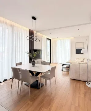Spacious living room with a dining area and modern furniture. - image 13
