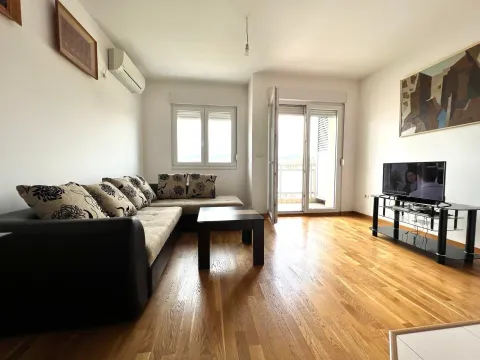 Svijetao dnevni boravak sa ugaonom garniturom, drvenim podom i izlazom na terasu. - image 2