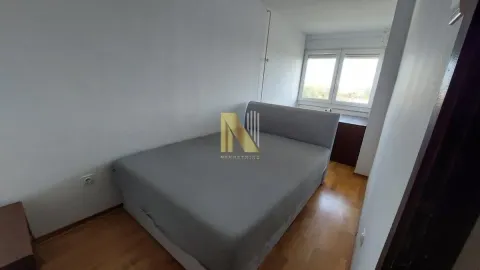 Smaller bedroom with a double bed and parquet flooring. - image 9