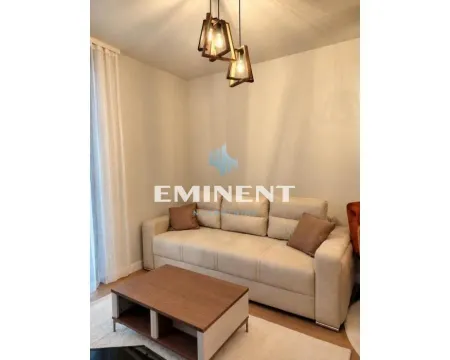 Living room with a beige sofa, coffee table, and modern chandelier. - image 10
