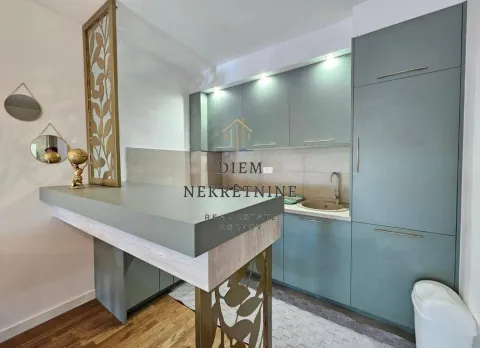 Modern kitchen with a breakfast bar and green cabinetry. - image 7