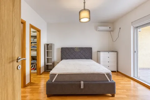 Furnished bedroom with a double bed, air conditioning, and balcony access. - image 6