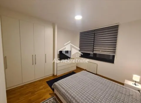 Furnished bedroom with a double bed, built-in wardrobe, and a window with blinds. - image 10