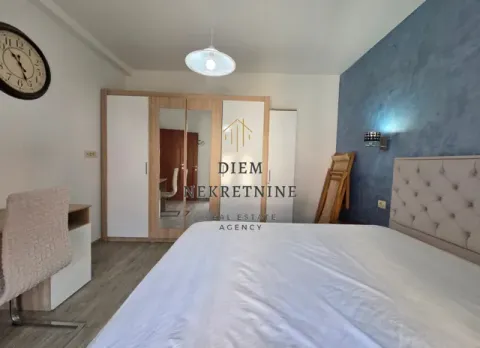 Furnished bedroom with a double bed, wardrobe, and wall clock. - image 7