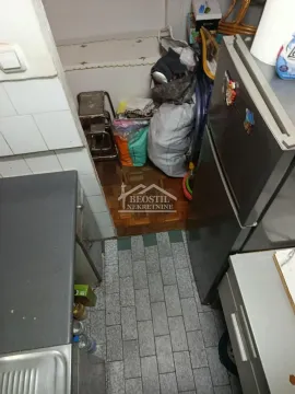 View of part of the kitchen with a refrigerator and cabinets. - image 11