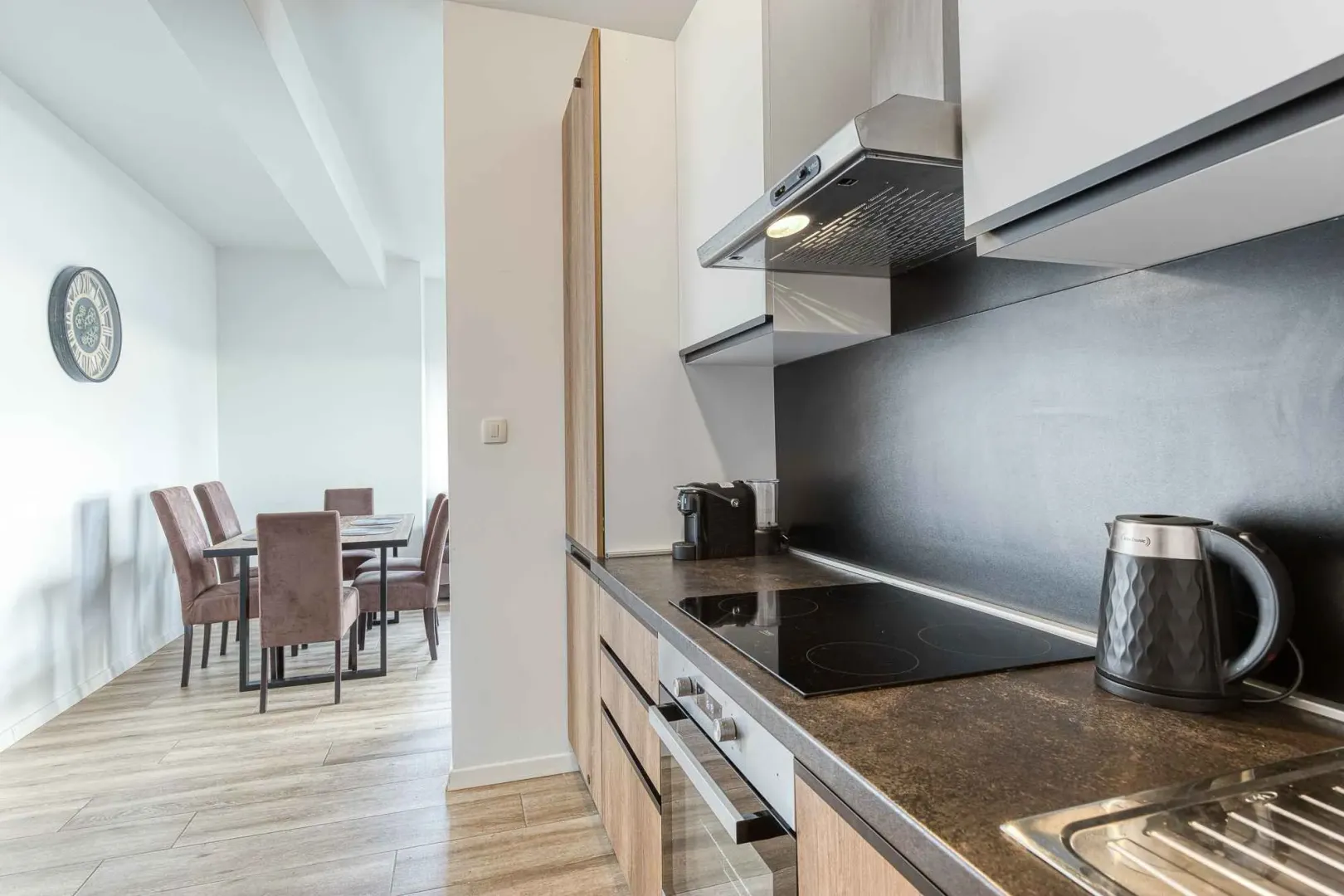 Modern kitchen with a built-in cooktop and a view of the dining area.