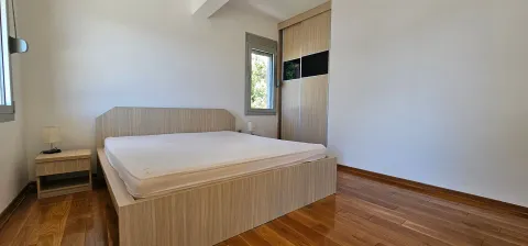Bright bedroom with a double bed, wooden floor and built-in wardrobe. - image 8